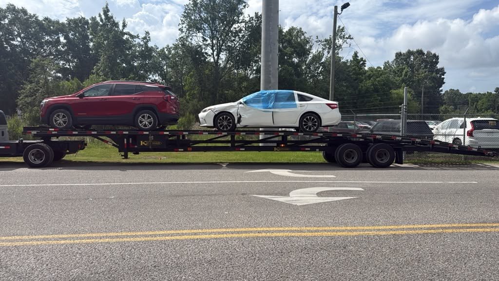 MEYP LLC open trailer loaded with vehicles